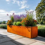 Decorative metal planter with flowers on a stone patio