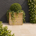 50cm Deluxe Square Redwood Planter planted in a garden setting