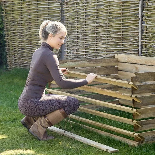 A Woman Operating an Easy Load Compost Bin