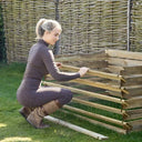 A Woman Operating an Easy Load Compost Bin