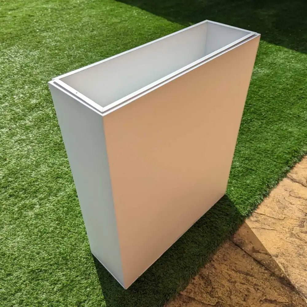 Tall rectangular planter in crisp white with an insert, ideal for creating a layered garden display.