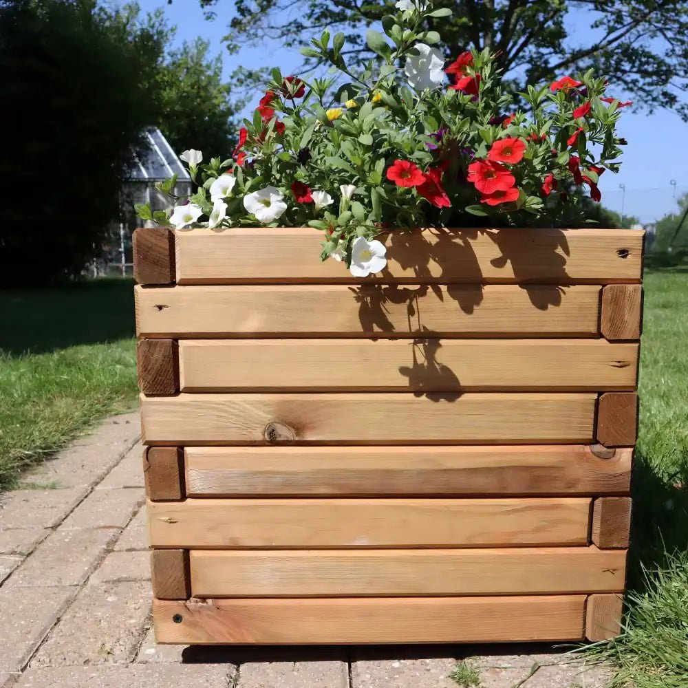 A weathered hardwood planter box, adding character and charm to a garden setting, 90cm long by Woven Wood