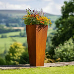 Corten Steel planter with flowers against a scenic background