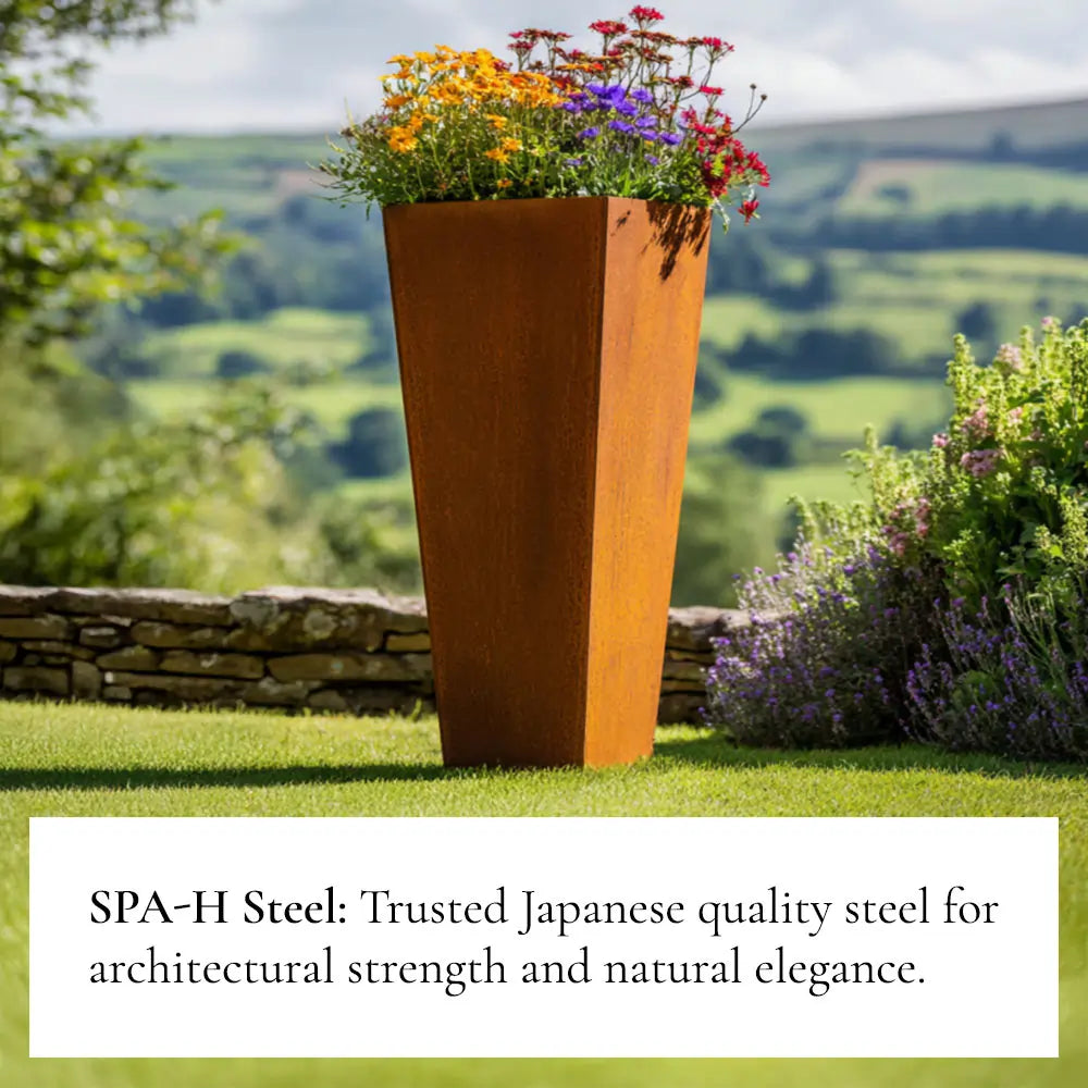 Tall rust-colored Corten steel planter with flowers in a garden setting, featuring SPA-H Steel text.