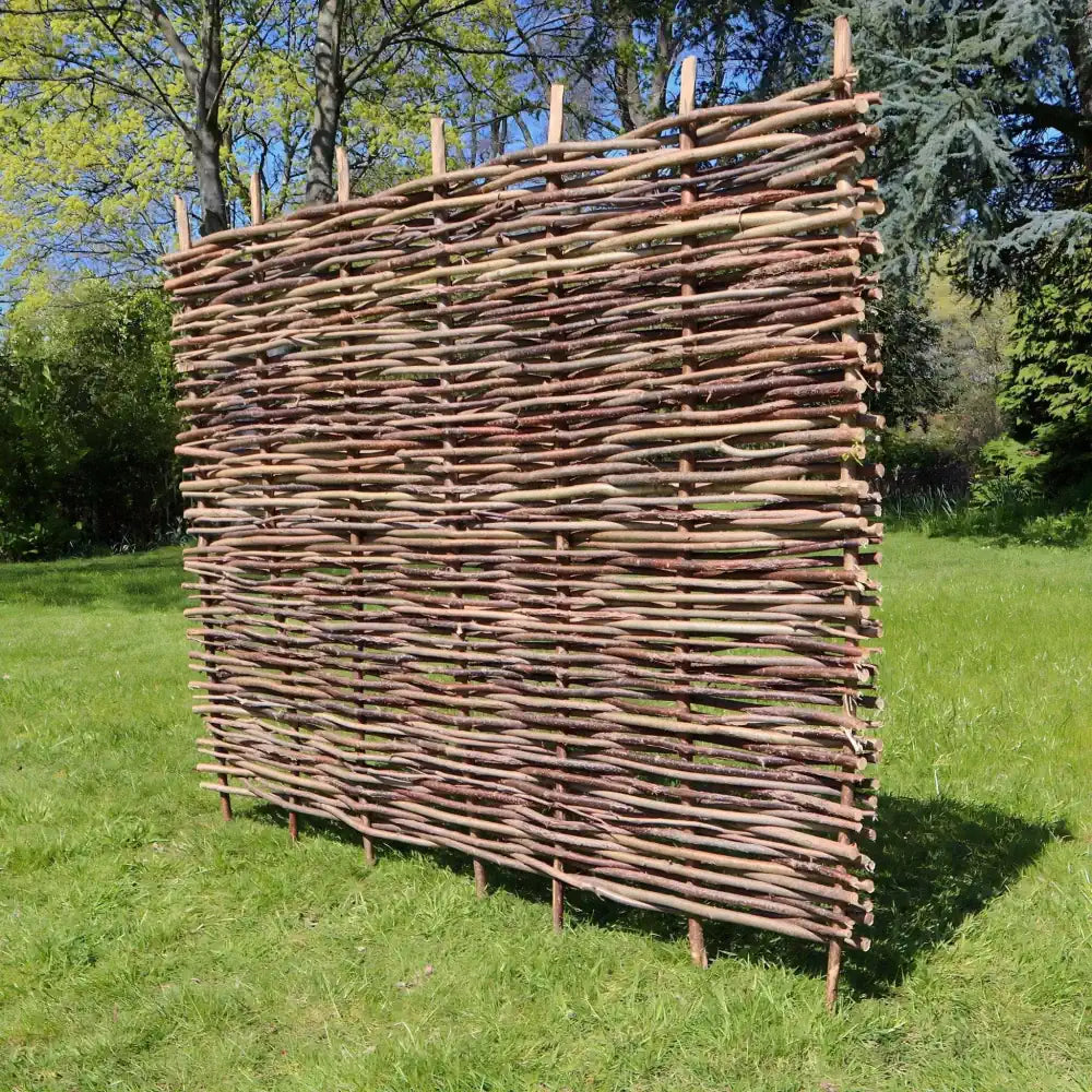 Hazel fencing: Woven Wood's hazel fencing is made from high-quality hazel hurdles, handcrafted for a long-lasting and attractive finish