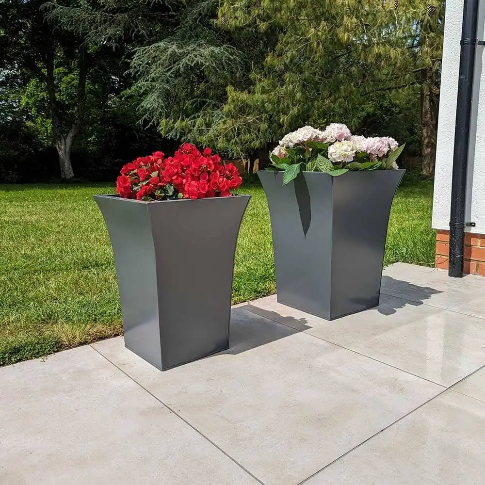 Large plant pots arranged around a patio area