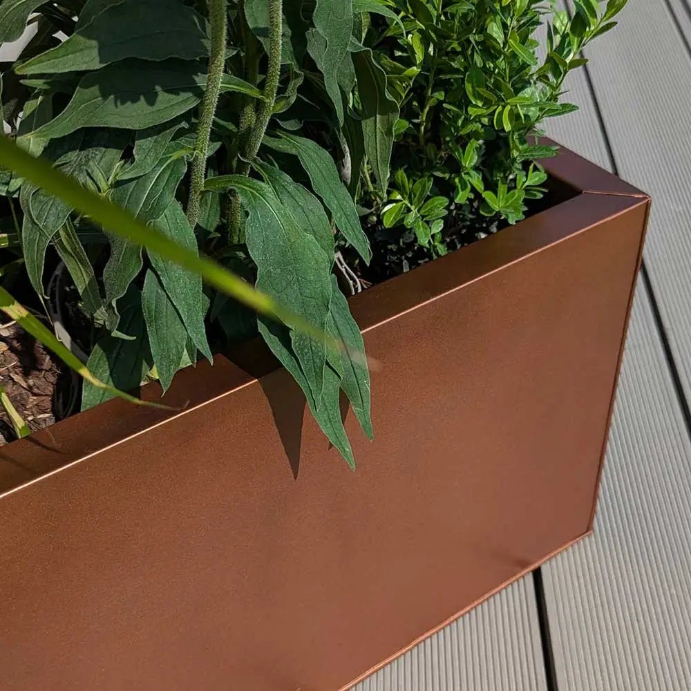 copper brown zinc trough planter with plants