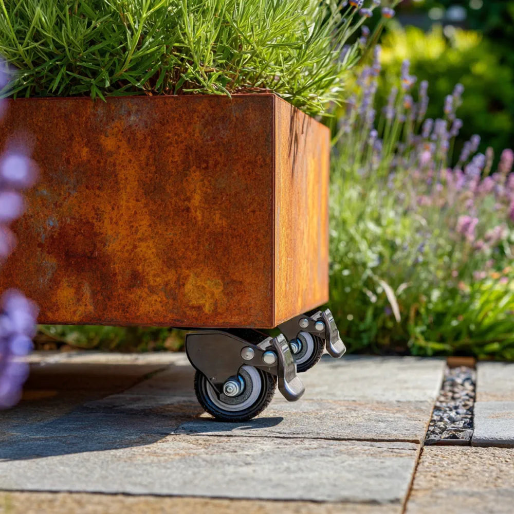 Corten steel planter with wheels on a garden path