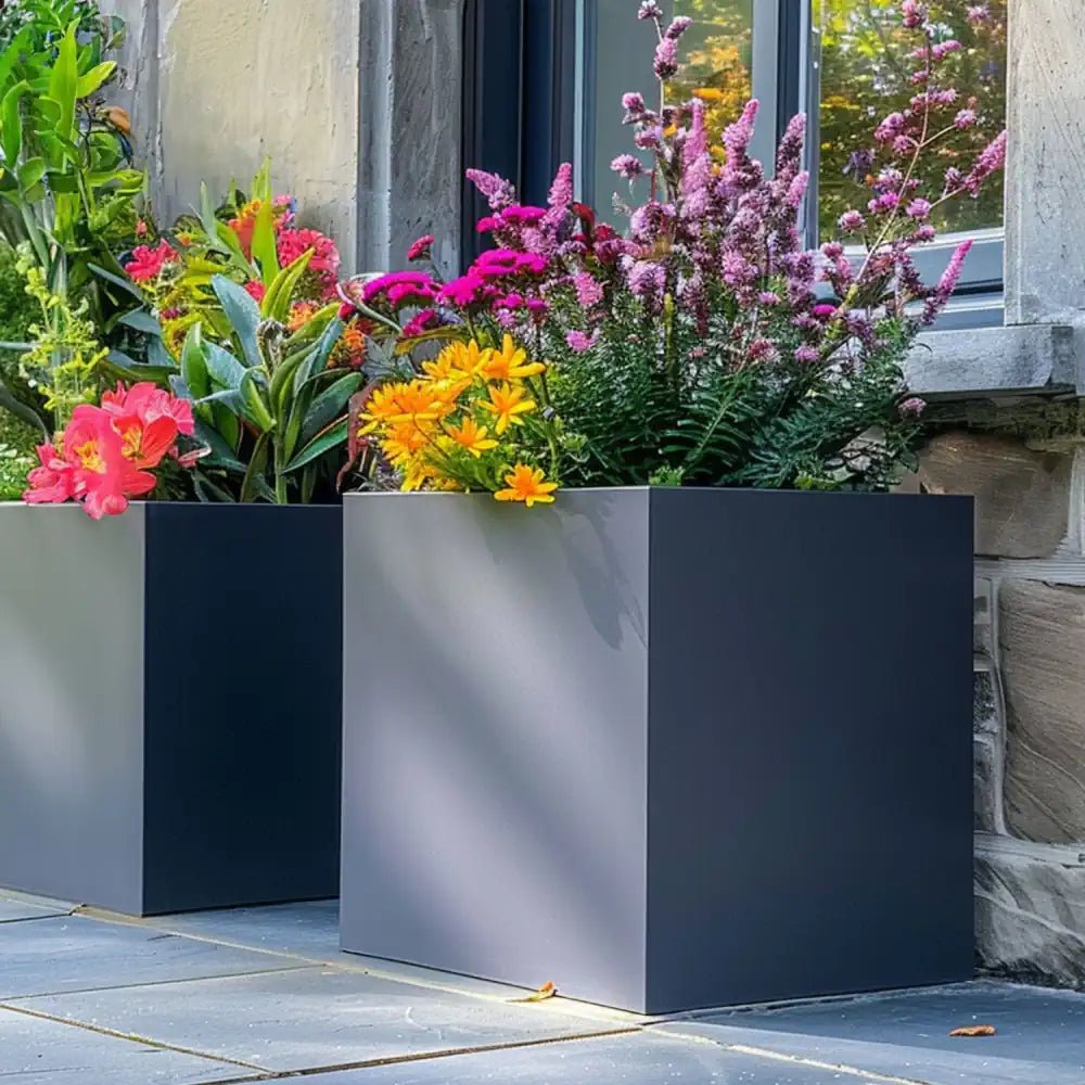 A row of sleek white trough planters, brimming with vibrant blooms.