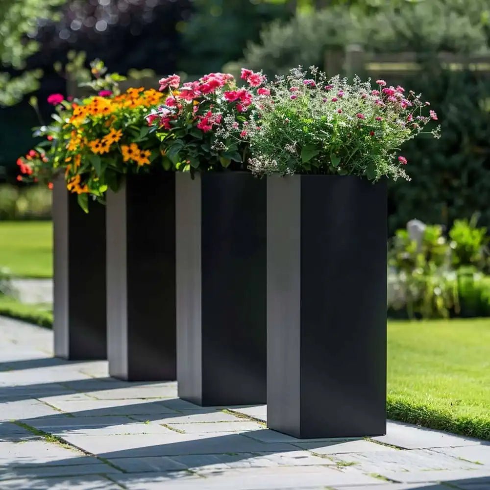 Contemporary tall black planters lining the sidewalk.