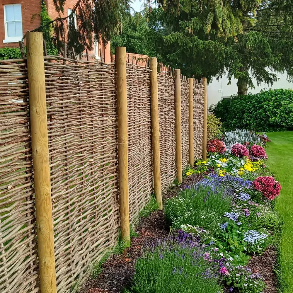 Woven hazel hurdles forming a soft boundary between the park and the neighbouring lane.