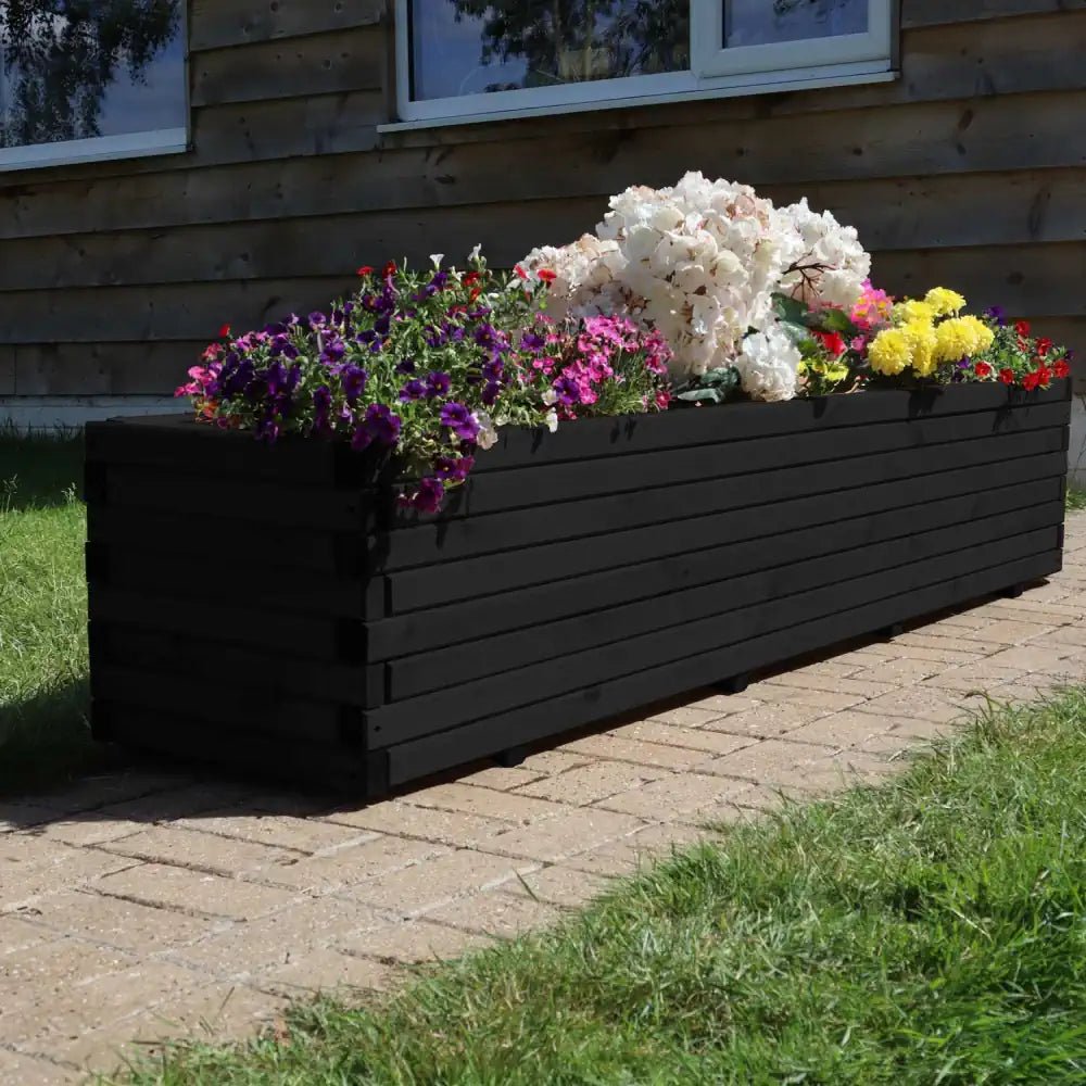 Massive wooden planters add drama and elegance to your outdoor space, perfect for showcasing mature plants.