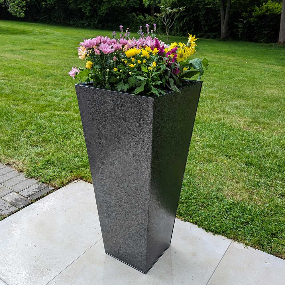 A collection of long planters in a modern garden