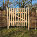 Hazel hurdle gate blending harmoniously with the countryside.