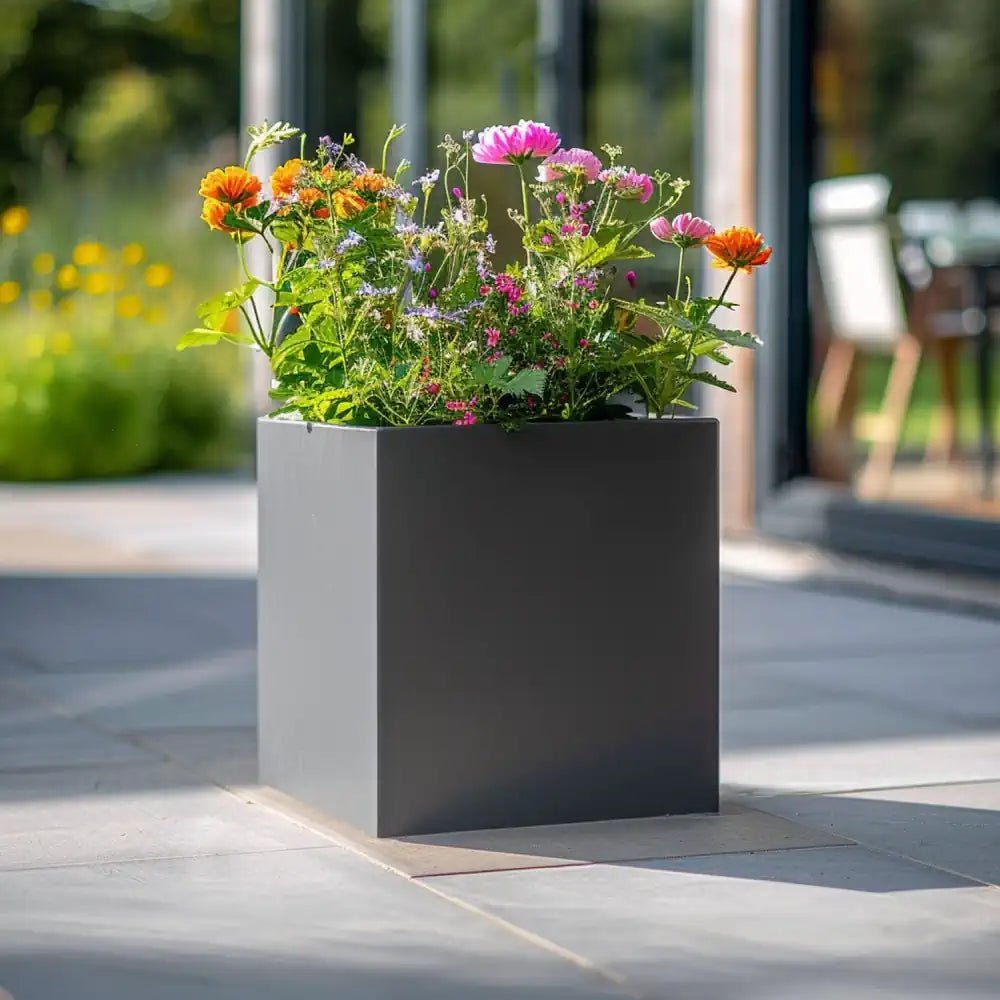 A grey planter brimming with lush greenery, enhancing the beauty of the surroundings.