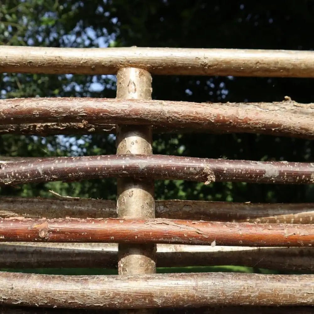 Durable hazel fencing panels designed to withstand the elements while adding rustic charm.