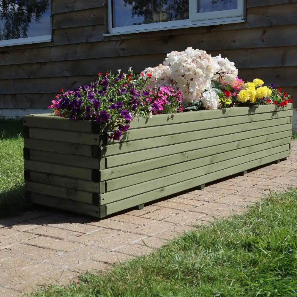 Greet guests with an impressive green wooden planter showcasing vibrant greenery.