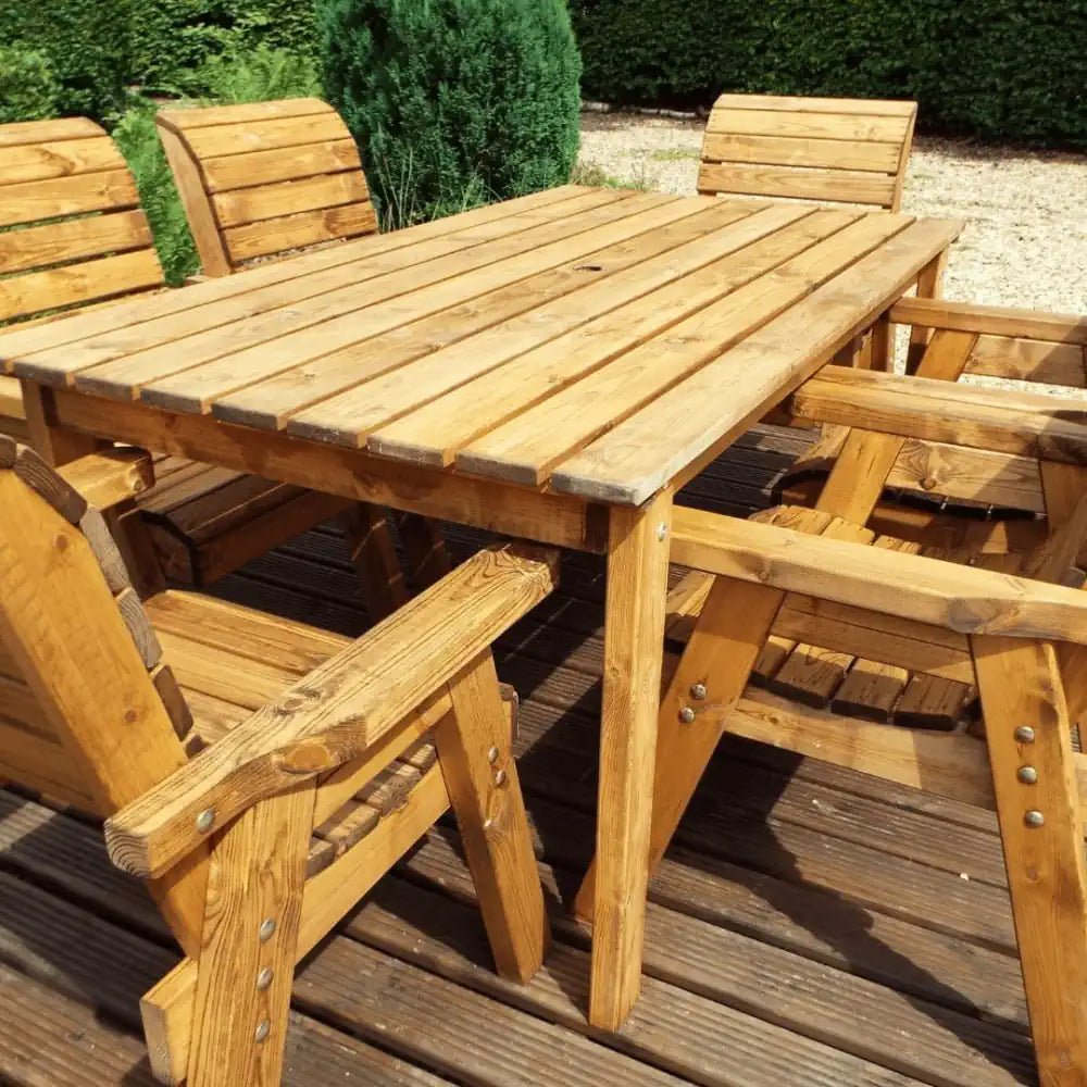 Teak outdoor dining table with green parasol by Woven Wood
