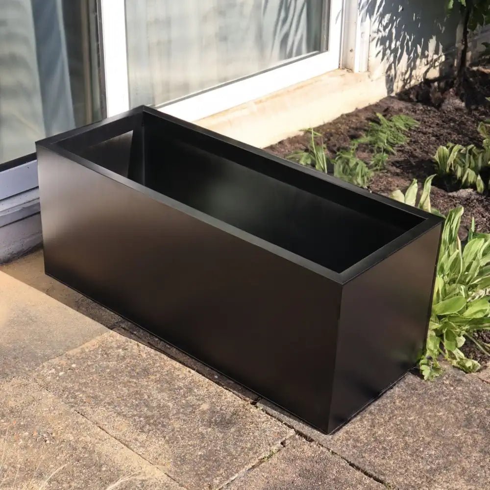 Large, industrial zinc planter makes a bold statement in any garden, adding modern flair.