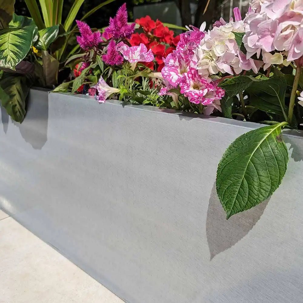 Large trough planters brimming with lush foliage.