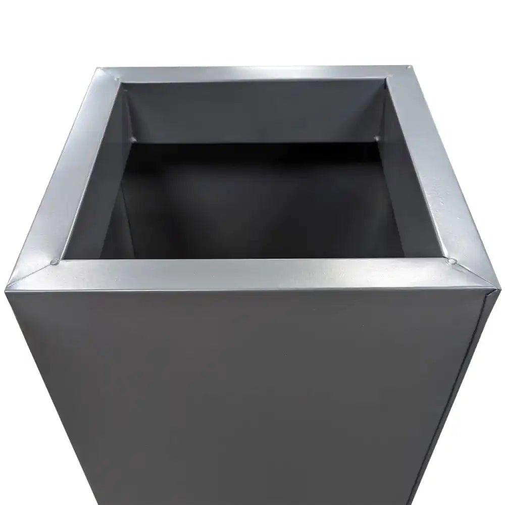 Large grey trough planter standing proudly as a focal point in a garden.