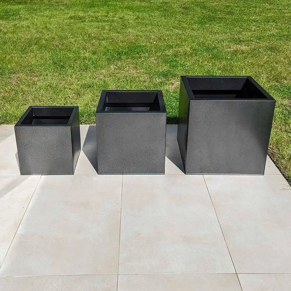Metal planters adding an industrial touch to the garden.