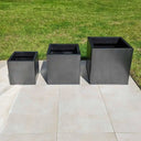 Metal planters adding an industrial touch to the garden.