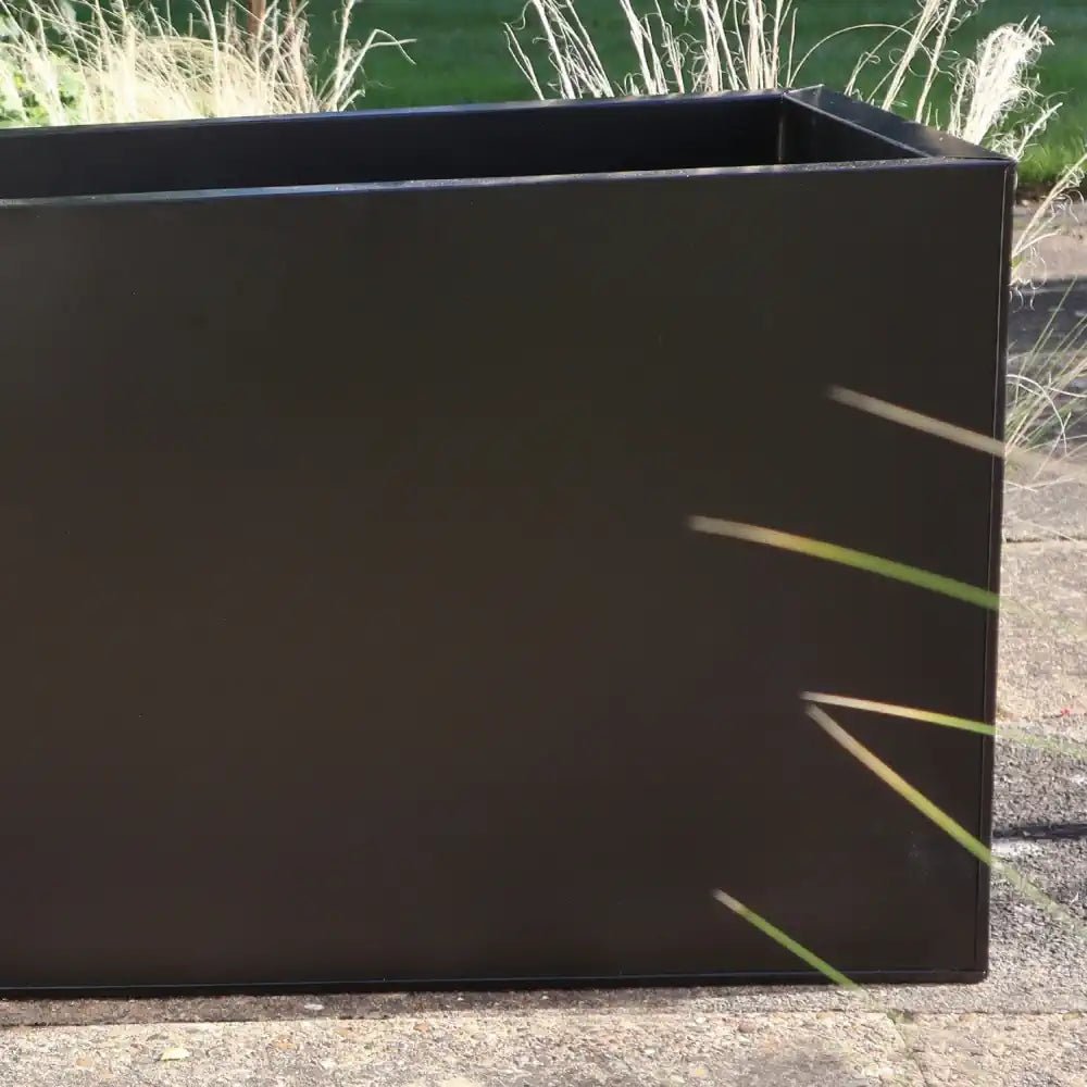 Weatherproof zinc planter withstands the elements, perfect for year-round outdoor enjoyment.