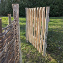 Garden gate framed by lush greenery.
