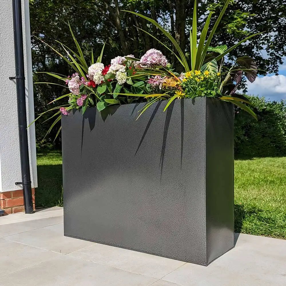 Large outdoor planters in a landscaped yard