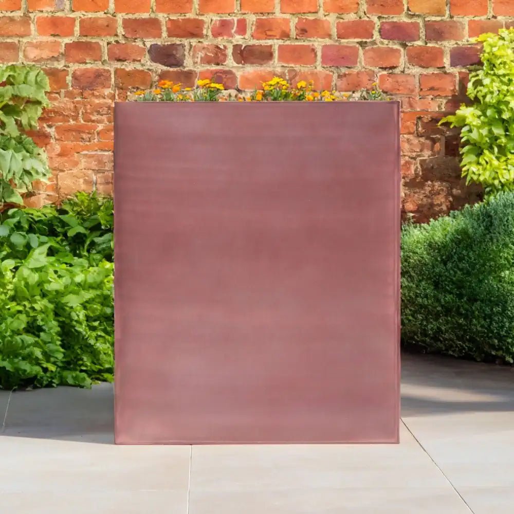 Elongated rose gold planter made of metal, suitable for adding a touch of elegance to any indoor space.