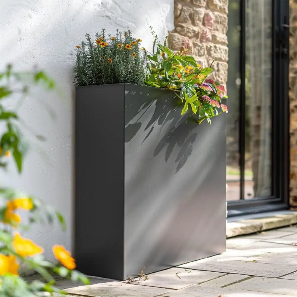 Outdoor grey plant pots blending seamlessly with natural surroundings.