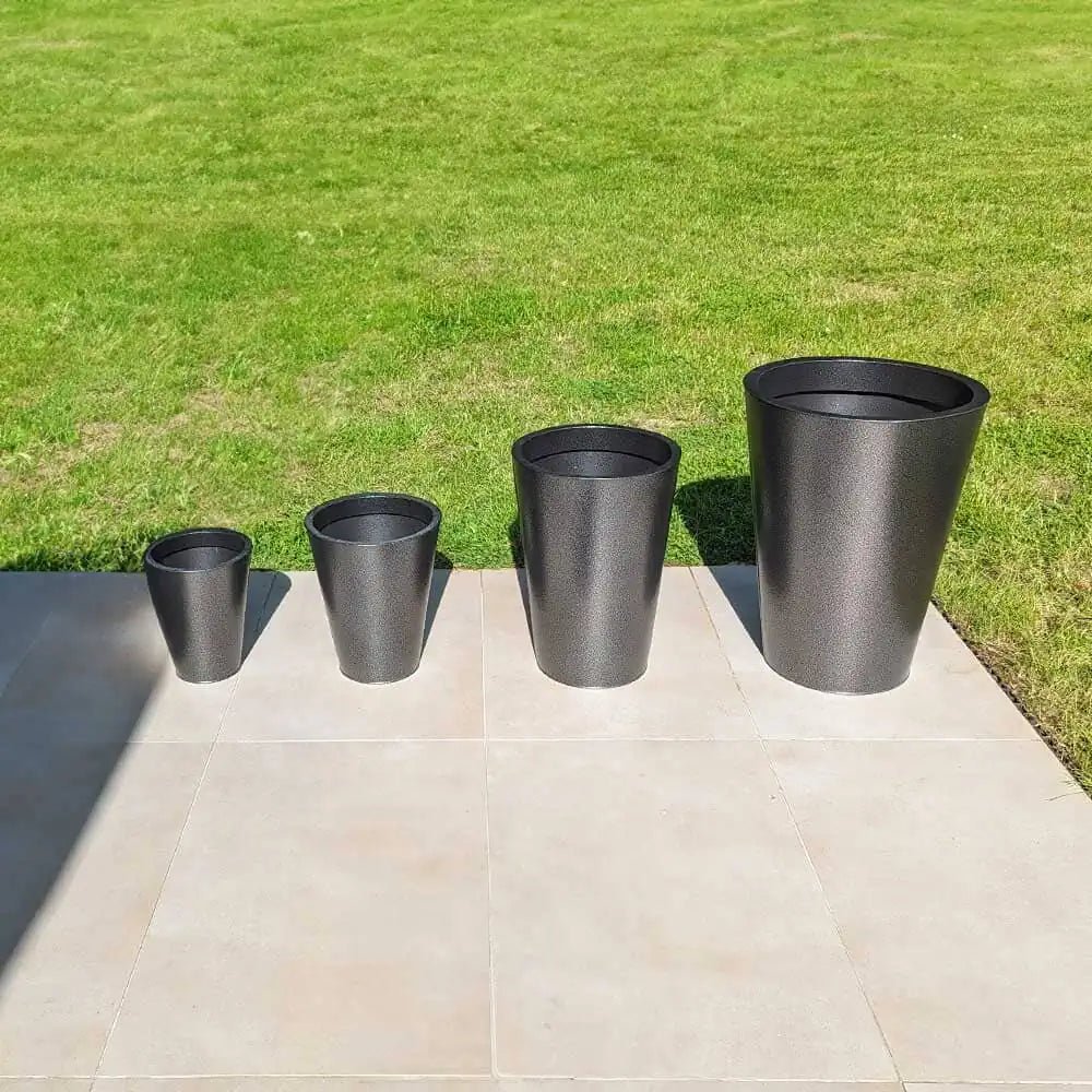 Large plant pots grouped in a corner of a living room