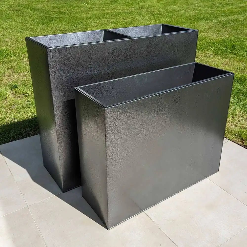Large trough planters filled with colorful blooms
