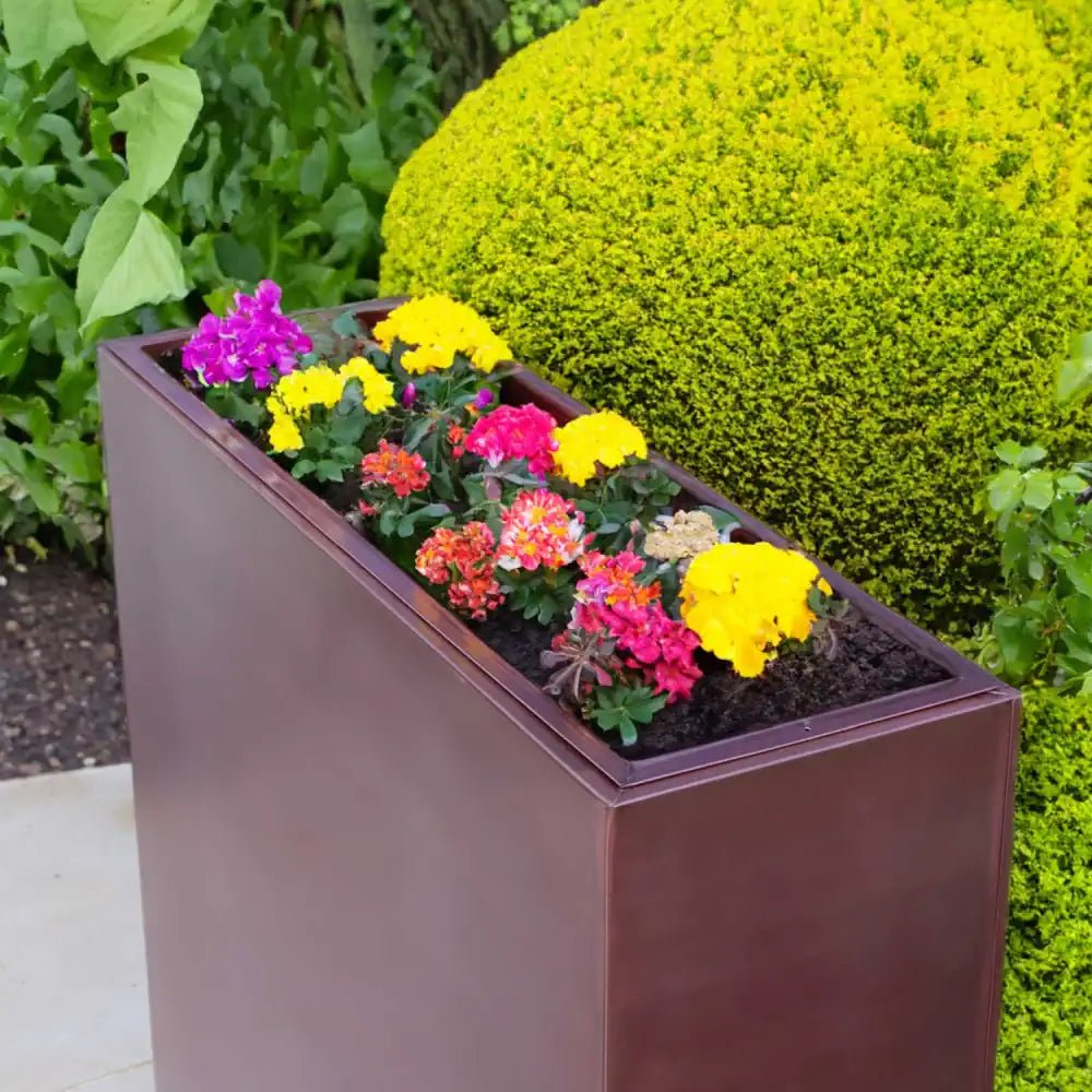 Rose gold colored tall planter with a rectangular trough design, perfect for space-saving plant arrangements.