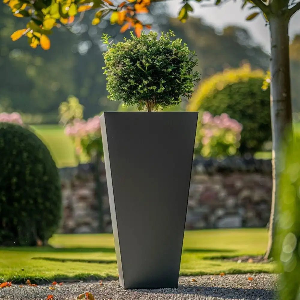 A tall planter accentuating vibrant blooms.