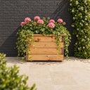 Valley Square Planter planted in a garden setting