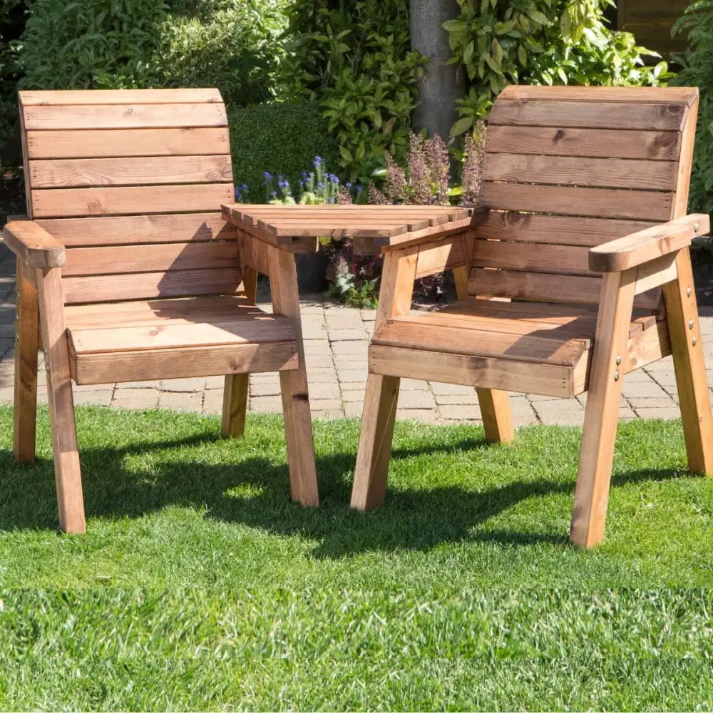 Serenity corner: A natural wooden garden love seat nestled among blossoms.